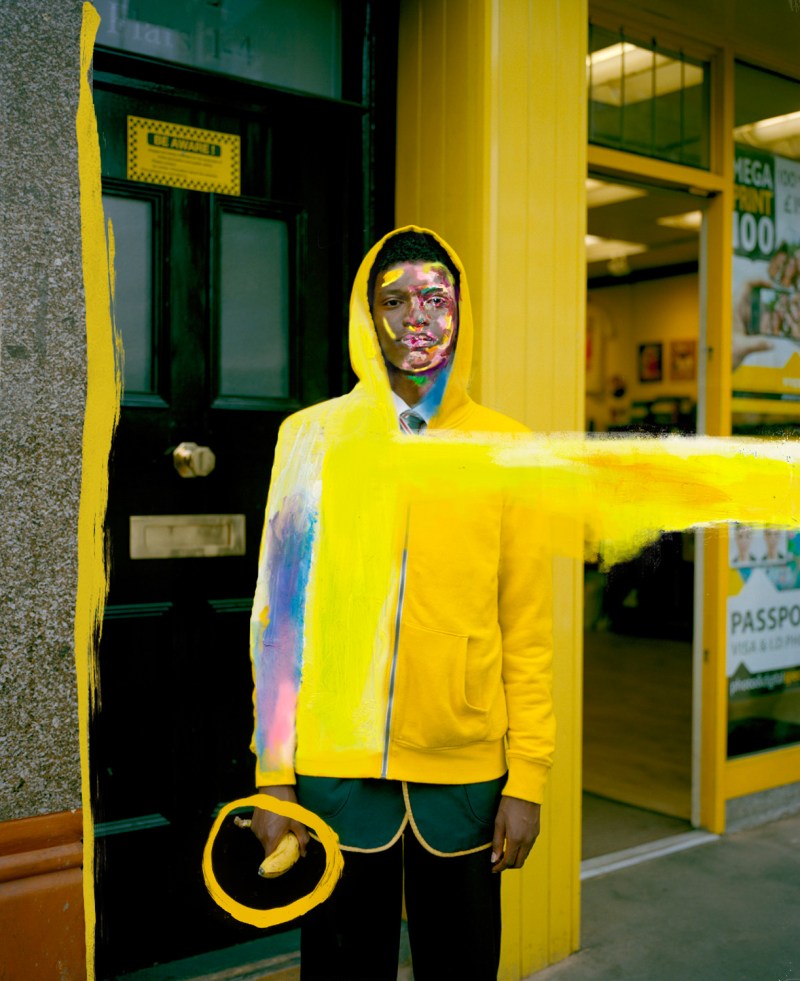 Schooboy with banana, Croydon, South London - May 2015